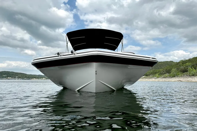 Slide: The Image of 2014 Hurricane SunDeck Sport 202 IO boat on calm water under cloudy sky. - 9