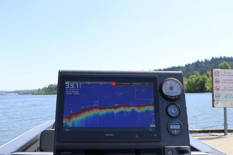 Slide: The Image of Alumaweld Pacific CC 26 boat with Garmin fishfinder on a scenic lake. - 13