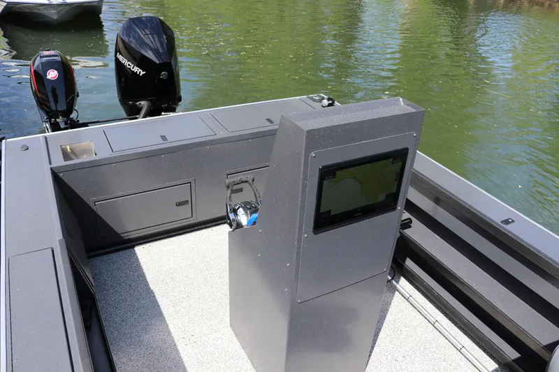 Slide: The Image of 2026 Alumaweld Pacific CC 26 boat interior with Mercury engines on a calm water surface. - 14