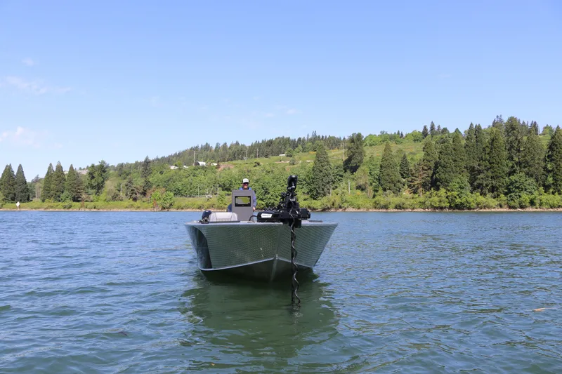 Slide: The Image of 2026 Alumaweld Pacific CC 26 boat on a scenic lake with forested shoreline. - 3