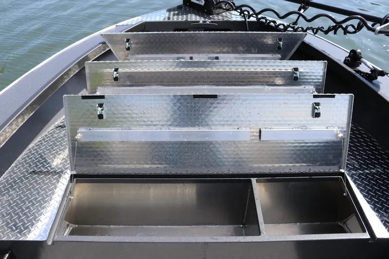 Slide: The Image of Alumaweld Pacific CC 26 boat storage compartments, 2026 model, open on a calm water surface. - 23
