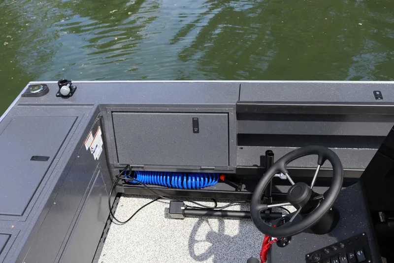 Slide: The Image of 2026 Alumaweld Pacific CC 26 boat helm with steering wheel and control panel. - 15