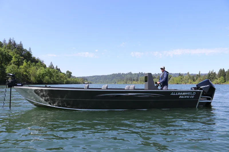 Slide: The Image of 2026 Alumaweld Pacific CC 26 boat on a scenic lake with lush green surroundings. - 6