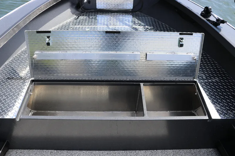 Slide: The Image of 2026 Alumaweld Pacific CC 26 boat storage compartment with open metal lid. - 24