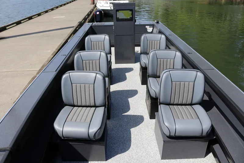 Slide: The Image of 2026 Alumaweld Pacific CC 26 boat interior with six gray seats, dockside view. - 8