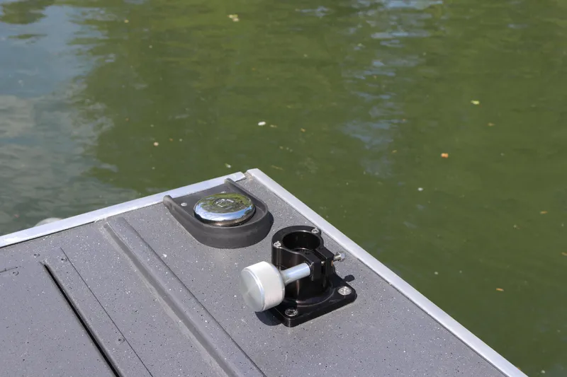 Slide: The Image of 2026 Alumaweld Pacific CC 26 boat deck detail with rod holder and water background. - 30