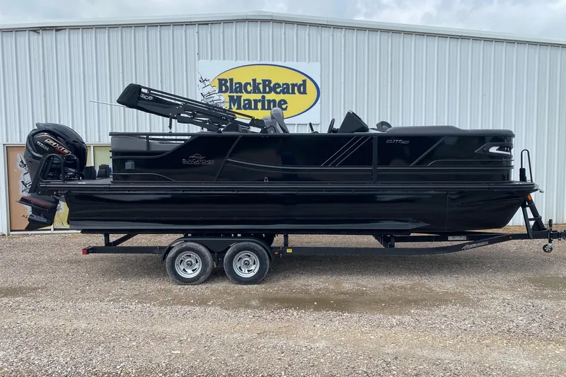 The Image of 2026 SunCatcher Elite 324 SS pontoon boat on trailer at BlackBeard Marine dealership. - 0