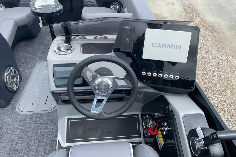 Slide: The Image of 2026 SunCatcher Elite 324 SS boat dashboard with Garmin navigation system and steering wheel. - 10