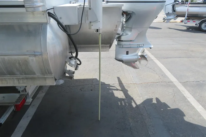 Slide: The Image of 2014 Avalon Catalina Fish 24' pontoon boat with outboard motor in parking lot. - 11