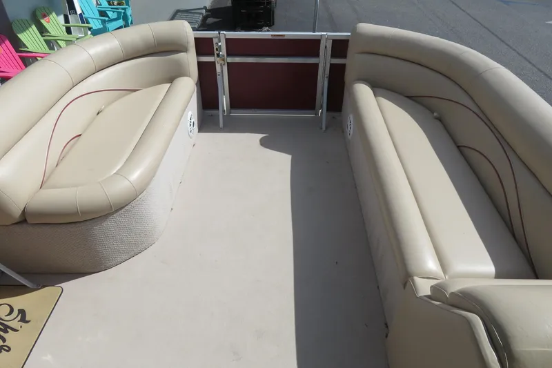 Slide: The Image of 2014 Avalon Catalina Fish 24' boat interior with beige seating and open deck space. - 13