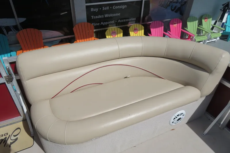 Slide: The Image of 2014 Avalon Catalina Fish 24' boat with beige seating and colorful chairs in the background. - 15