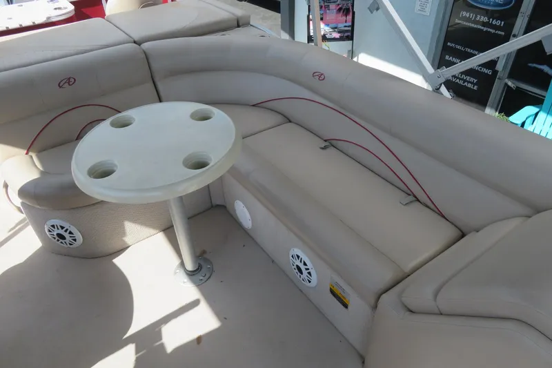 Slide: The Image of Luxurious seating area on a 2014 Avalon Catalina Fish 24' boat with cupholder table. - 16