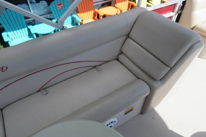 Slide: The Image of 2014 Avalon Catalina Fish 24' boat interior with beige seating and colorful chairs. - 17