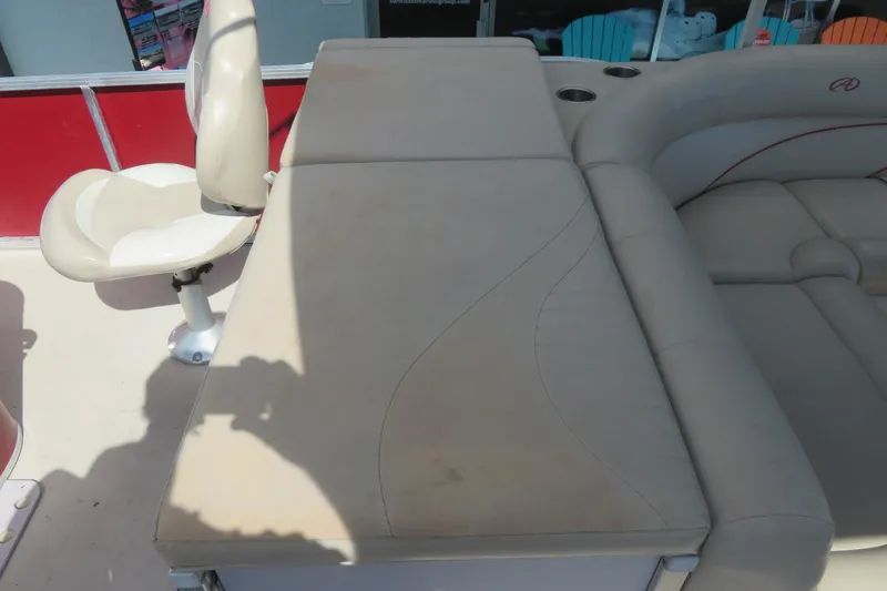 Slide: The Image of 2014 Avalon Catalina Fish 24' boat interior with beige seating and swivel chair. - 18