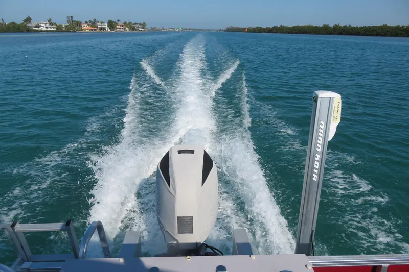 Slide: The Image of 2014 Avalon Catalina Fish boat cruising on clear blue water, leaving a wake. - 2