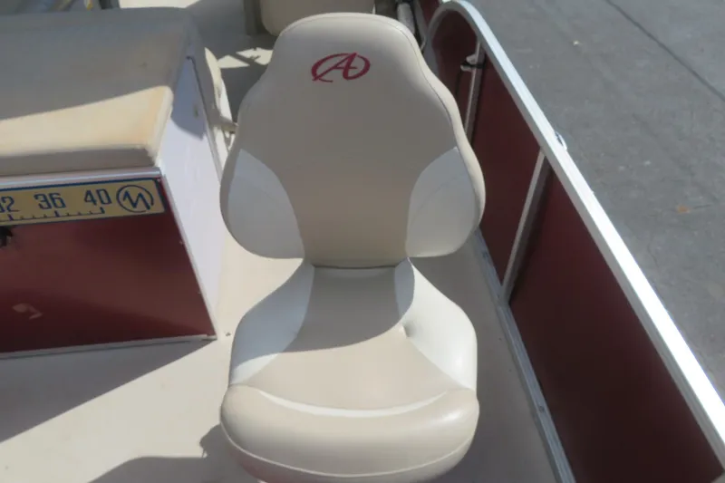 Slide: The Image of Boat seat on 2014 Avalon Catalina Fish 24', featuring beige upholstery and red logo. - 21