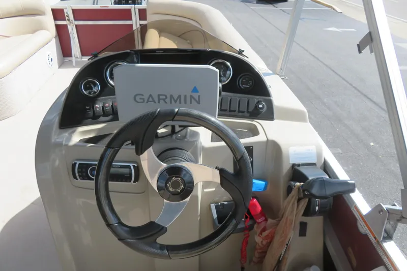 Slide: The Image of Steering console of 2014 Avalon Catalina Fish 24' boat with Garmin navigation system. - 24