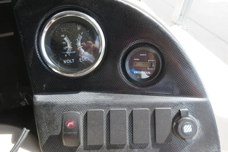 Slide: The Image of Dashboard of 2014 Avalon Catalina Fish boat with volt, fuel gauges, and Honda hour meter. - 25