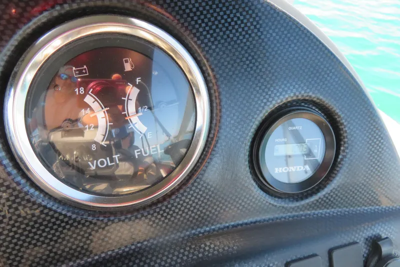 Slide: The Image of Close-up of 2014 Avalon Catalina Fish dashboard gauges, showing volt and fuel levels. - 26