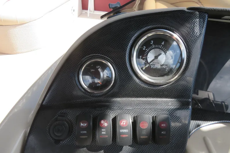 Slide: The Image of Dashboard of 2014 Avalon Catalina Fish boat with RPM gauge and control switches. - 28