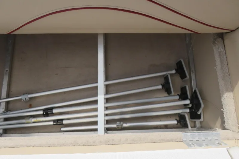 Slide: The Image of Storage compartment with metal rods inside a 2014 Avalon Catalina Fish 24' boat. - 36