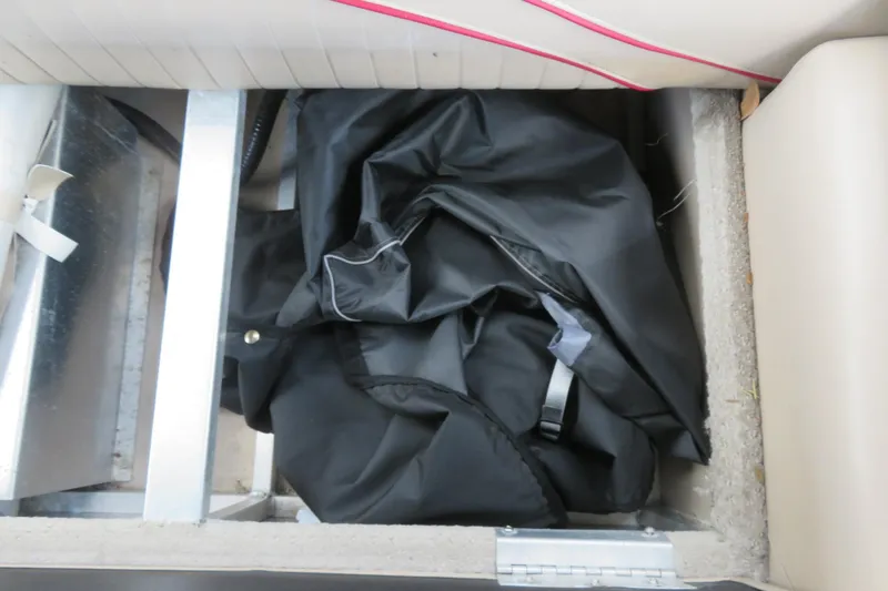 Slide: The Image of Storage compartment in 2014 Avalon Catalina Fish boat with black cover inside. - 37