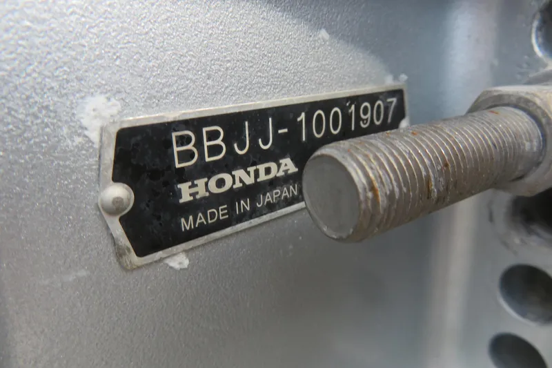 Slide: The Image of Close-up of a Honda engine plate with serial number BBJJ-1001907. - 39