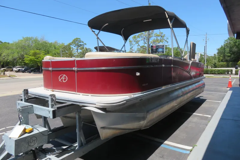 Slide: The Image of 2014 Avalon Catalina Fish 24' pontoon boat on trailer in parking lot. - 5