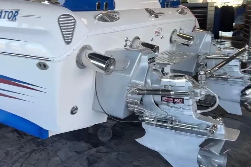 Slide: The Image of 2007 Eliminator 30 Daytona boat with dual outboard engines in a garage setting. - 11