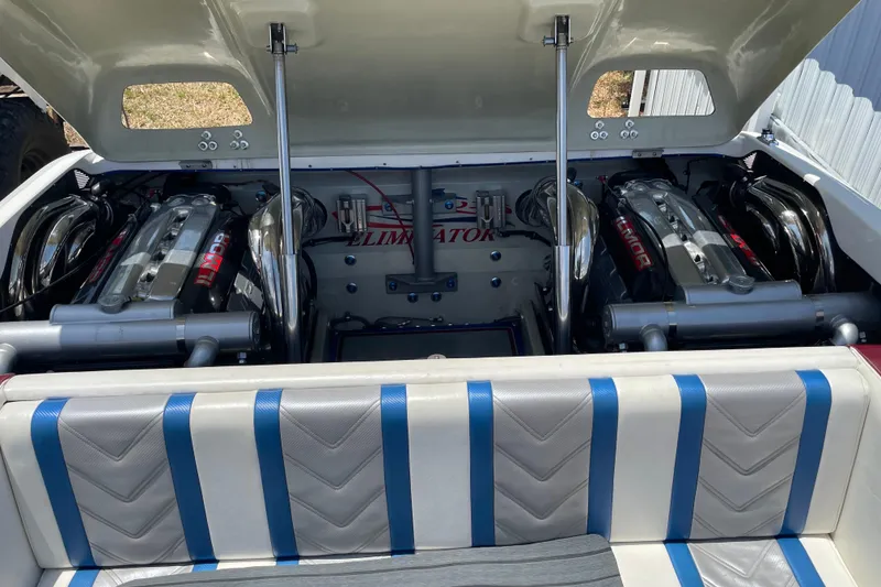 Slide: The Image of 2007 Eliminator 30 Daytona boat engine compartment with dual engines and upholstered seating. - 12