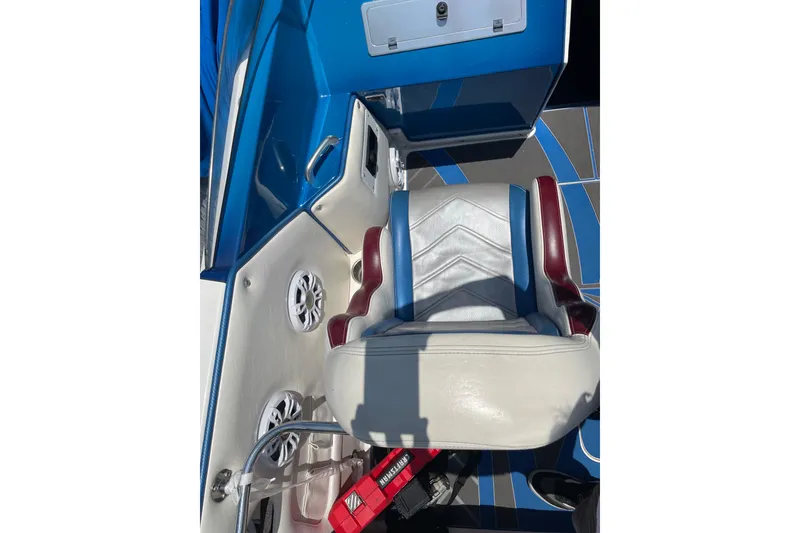 Slide: The Image of Interior of a 2007 Eliminator 30 Daytona boat with blue and white seating. - 13
