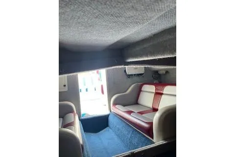 Slide: The Image of Interior of a 2007 Eliminator 30 Daytona boat with red and white seating. - 16
