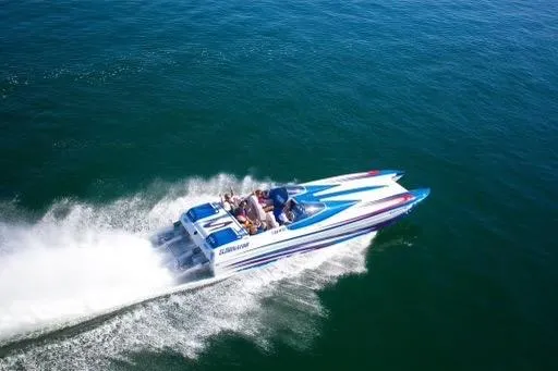 Slide: The Image of 2007 Eliminator 30 Daytona speedboat cruising on open water, showcasing sleek design and performance. - 4