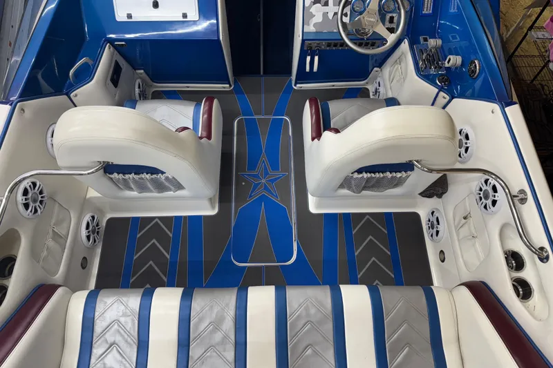 Slide: The Image of Interior of a 2007 Eliminator 30 Daytona boat with blue and white seating. - 5