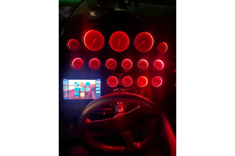 Slide: The Image of Dashboard of a 2007 Eliminator 30 Daytona boat with illuminated red gauges. - 6