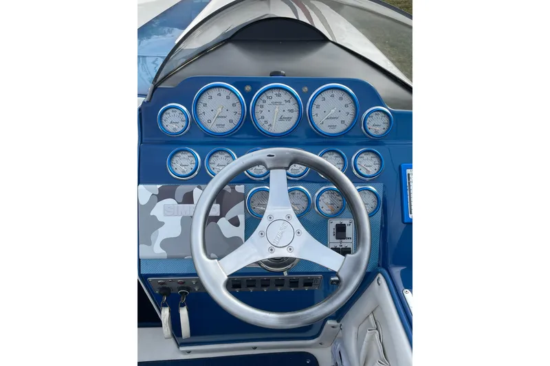 Slide: The Image of Dashboard of a 2007 Eliminator 30 Daytona boat with gauges and steering wheel. - 7