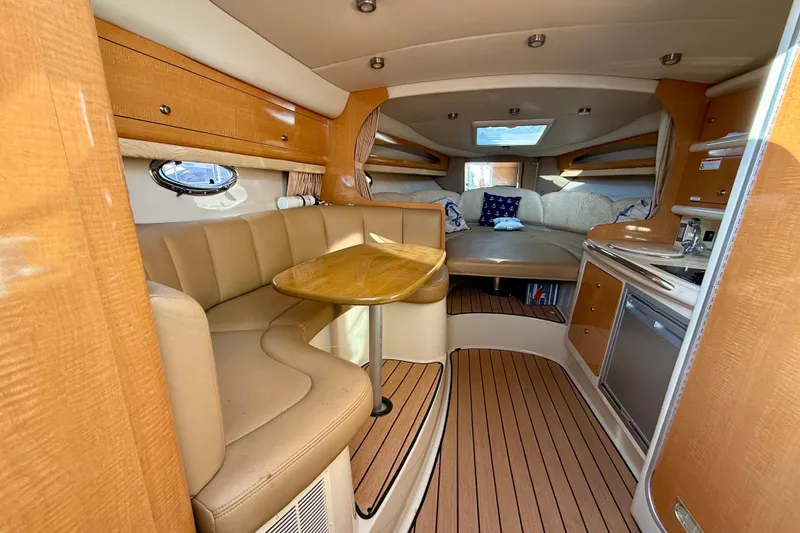 Slide: The Image of Interior of 2006 Chaparral Signature 290 boat with cozy seating and kitchenette. - 10
