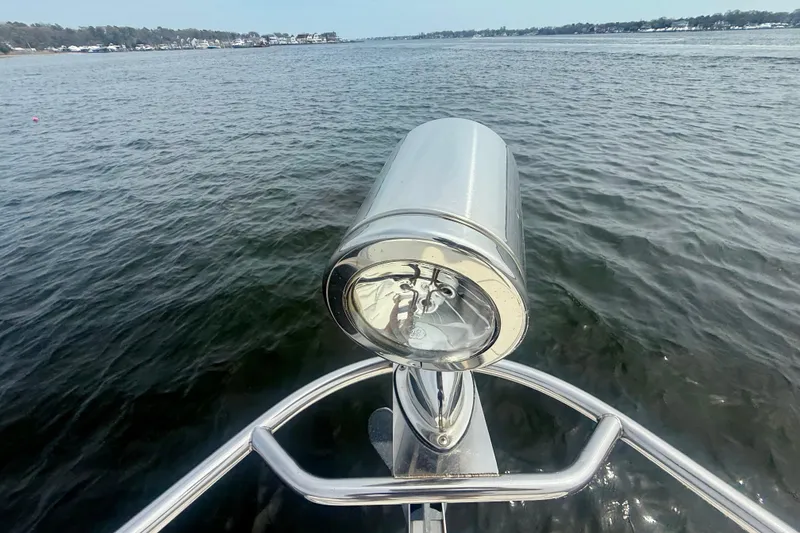 Slide: The Image of Bow view of 2006 Chaparral Signature 290 boat with spotlight on calm water. - 15