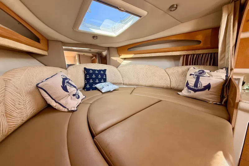 Slide: The Image of Interior of 2006 Chaparral Signature 290 boat with cozy seating and nautical-themed pillows. - 17