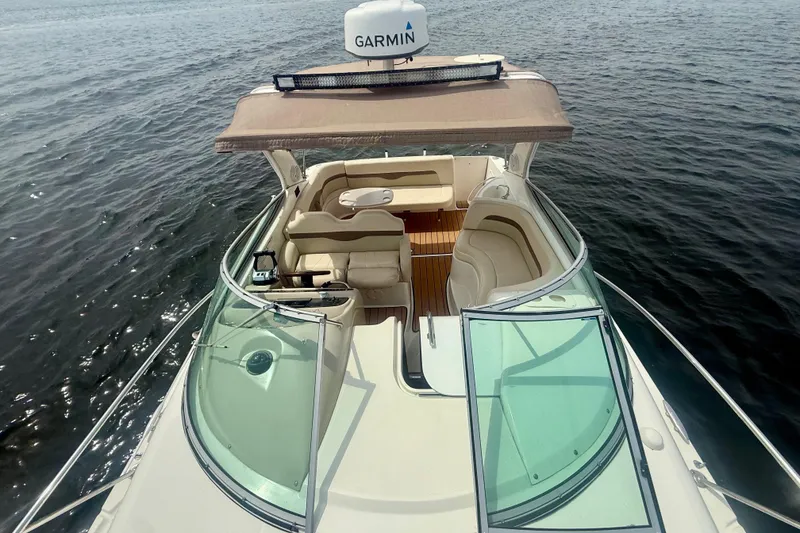 Slide: The Image of 2006 Chaparral Signature 290 boat with open deck and Garmin radar on water. - 21