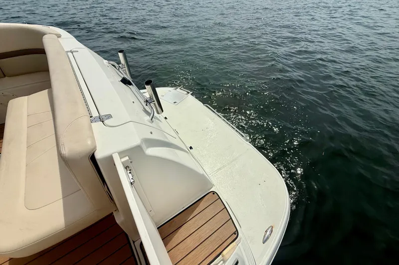 Slide: The Image of 2006 Chaparral Signature 290 boat deck with seating, overlooking calm water. - 24