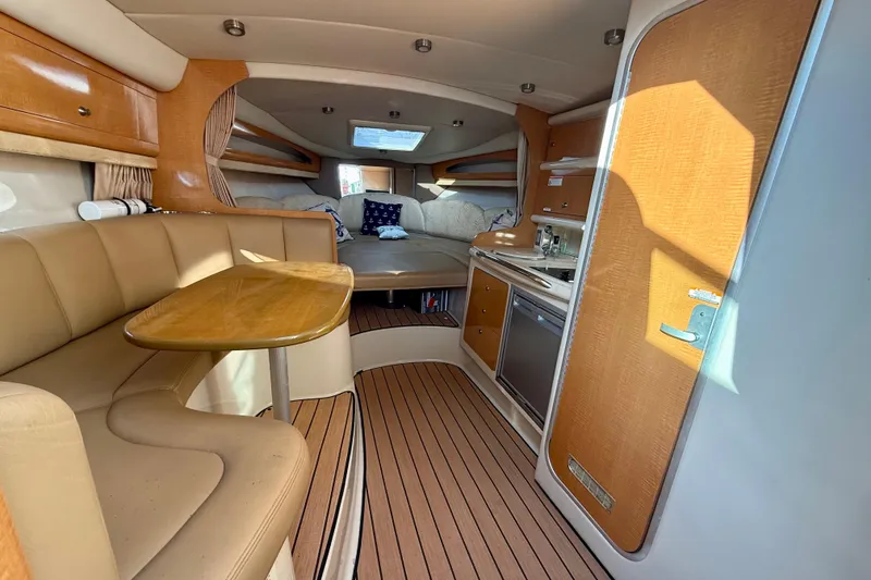 Slide: The Image of Interior of 2006 Chaparral Signature 290 boat with seating, table, and kitchenette. - 4