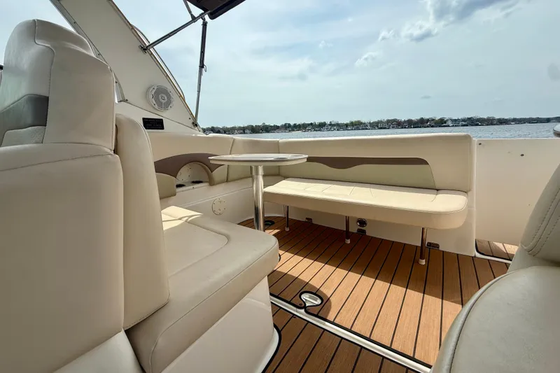 Slide: The Image of 2006 Chaparral Signature 290 boat interior with beige seating and wooden flooring. - 6