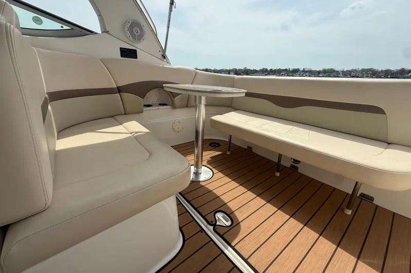 Slide: The Image of 2006 Chaparral Signature 290 boat interior with beige seating and wooden flooring. - 8