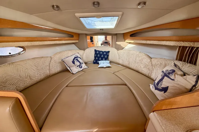 Slide: The Image of Interior of 2006 Chaparral Signature 290 boat with cozy seating and nautical-themed pillows. - 9