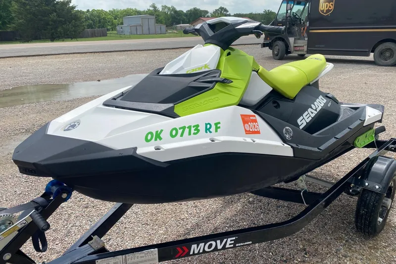 Slide: The Image of 2023 Sea-Doo Spark 3up jet ski on trailer, parked outdoors. - 3