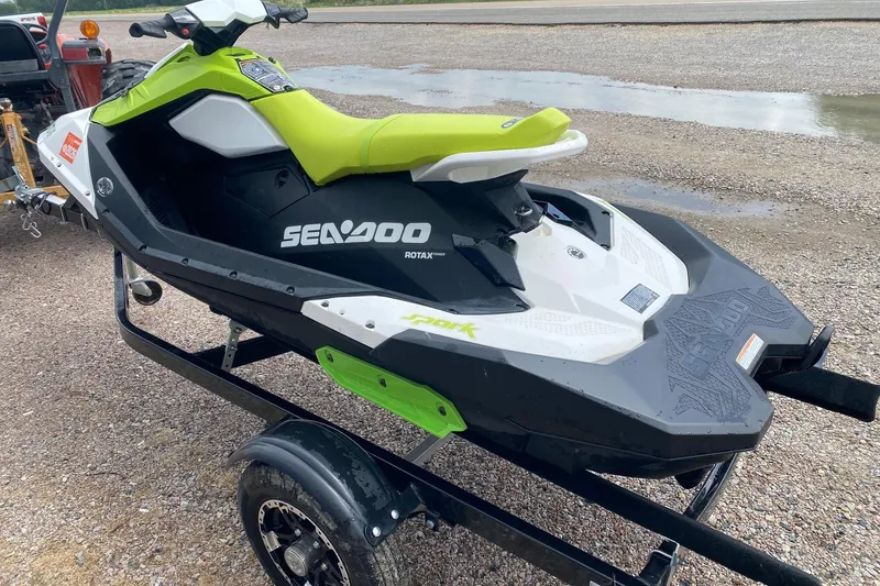 Slide: The Image of 2023 Sea-Doo Spark 3up jet ski on trailer, lime green and black design. - 4