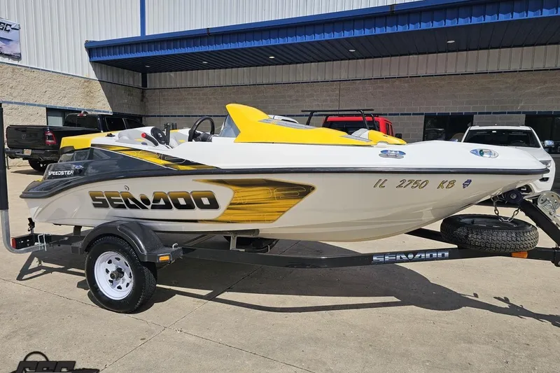 Slide: The Image of 2007 Sea-Doo 150 Speedster boat on trailer, yellow and white design, parked outdoors. - 10