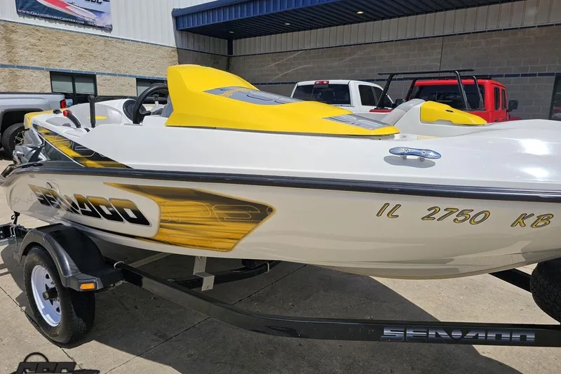 Slide: The Image of 2007 Sea-Doo 150 Speedster boat with yellow accents on a trailer, parked outdoors. - 11