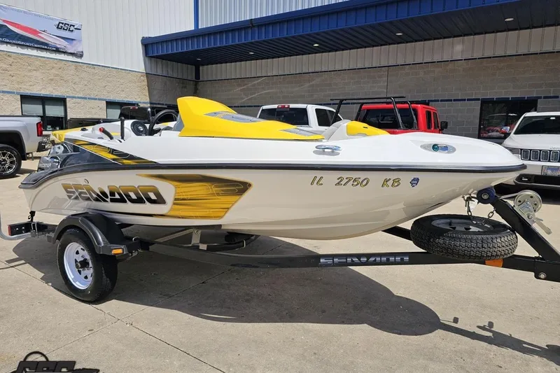 Slide: The Image of 2007 Sea-Doo 150 Speedster boat on trailer, white and yellow design, parked outdoors. - 12